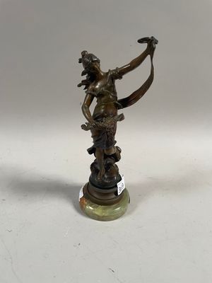 bronze figurine of a woman with a bow on a marble base