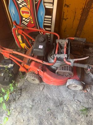 a red lawn mower that is sitting on the ground