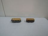 two toy buses that are sitting on a table
