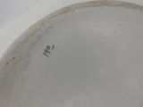 a white plate with a green number on it