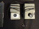 two old cameras sitting next to each other on a table