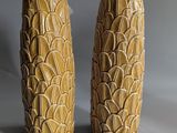 pair of yellow ceramic vases on grey background with grey background