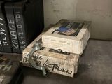 a stack of books sitting on the floor next to a pair of shoes