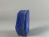 a close up of a blue stone ring on a white surface