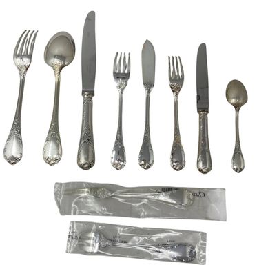 a set of silverware including a knife, fork, spoon, and spoon rest