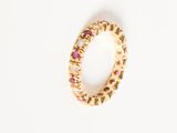 a close up of a gold ring with pink and white stones