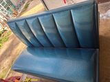 a blue bench that is sitting on the ground