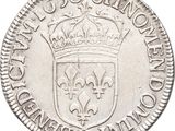 a close up of a silver coin with a crown on it