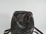 leather handbag with two handles and a strap on a white background