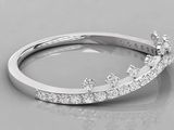 a close up of a diamond ring on a white surface