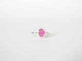 a pink sapphire and diamond ring on a white background