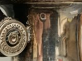 a silver vase that is sitting on a table