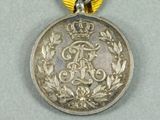 an image of a medal with a ribbon around it on a table