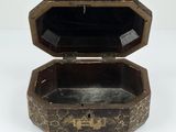 an old wooden box sitting on top of a white surface