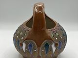 a brown vase with a blue and green design on it
