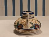 a blue and white vase sitting on a white table