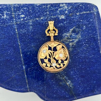 an image of a gold locke with a flower design on it