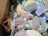 a cardboard box filled with many different types of clothing
