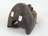 an old wooden elephant head with two white tags on it ' s face