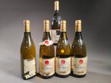several bottles of wine are lined up in a row on a table