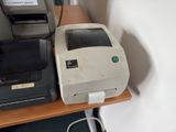 a printer and a printer on a desk next to each other