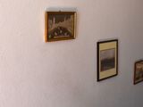 pictures on the wall above a toilet in a bathroom