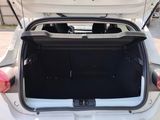 a white car with its trunk open on the side of the road