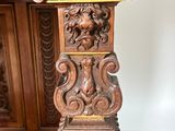 an antique carved wooden table with a lion head on top of it