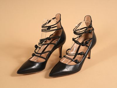 une paire de chaussures noires à talons hauts avec des lacets sur les orteils