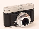 a black and silver camera with a silver lens