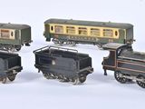 three toy trains sitting next to each other on a white surface
