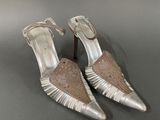 a close up of a pair of silver shoes on a table