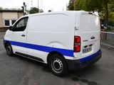 a white van with blue stripes parked in a parking lot