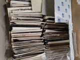 a cardboard box full of papers and a pair of scissors