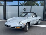 a silver sports car parked in front of a building