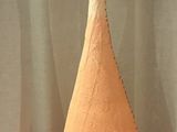 a large orange and white vase sitting on a table
