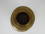 a gold plate with a brown center on a white table