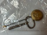 a key and a keychain in a bag on a table