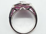 a close up of a ring with a pink stone in it