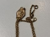 a gold chain that has a chain attached to it