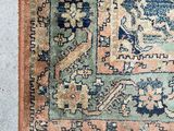 an image of a blue and orange rug with a bird on it