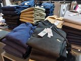 a lot of clothes that are on display in a store