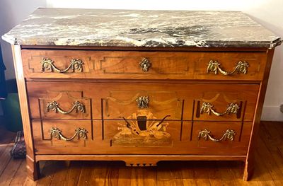 une commode en marbre sur un plancher en bois