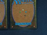 pair of magic the gathering deck cards on a black surface