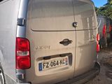 a silver van that is parked on the side of the road