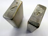 two silver bars sitting next to each other on a white surface
