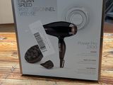 the box of the hair dryer is open on the table