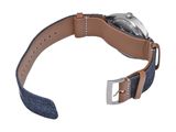 the watch strap is made of blue denim and has a silver buckle