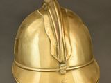 brass helmet on a metal stand on a black background