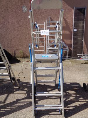 a ladder that is sitting in front of a building
